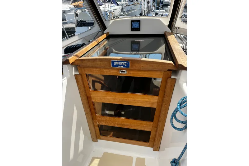 Slide: The Image of 2024 Tartan 395 yacht cockpit with wooden hatch and nautical equipment. - 57