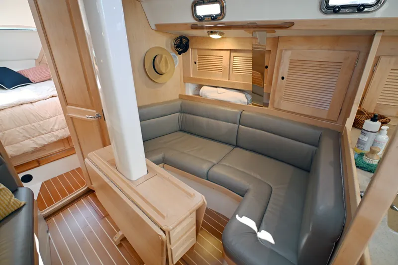 Slide: The Image of Luxurious interior of 2024 Tartan 395 yacht with cozy seating and elegant wood finishes. - 4