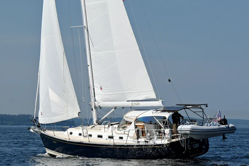 Slide: The Image of 2024 Tartan 395 sailboat cruising on open water with white sails. - 60