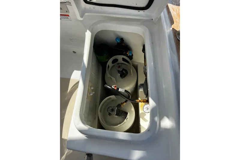 Slide: The Image of Open compartment of 2024 Tartan 395 boat showing gas cylinders and fittings. - 54