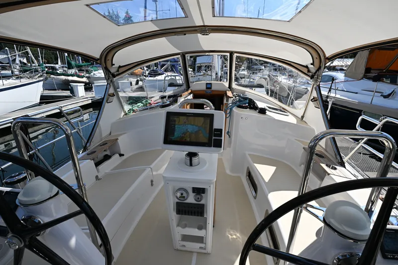 Slide: The Image of Cockpit of 2024 Tartan 395 sailboat with navigation equipment and dual steering wheels. - 39