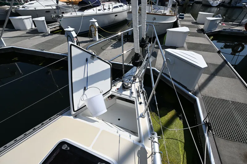 Slide: The Image of 2024 Tartan 395 sailboat docked, showcasing open hatch and deck details. - 32
