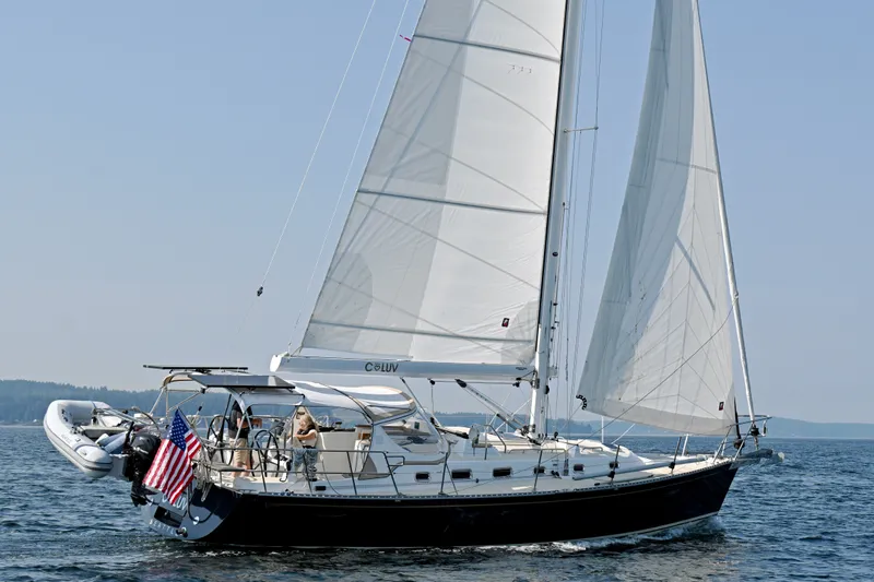 The Image of 2024 Tartan 395 sailboat cruising on open water with American flag. - 0
