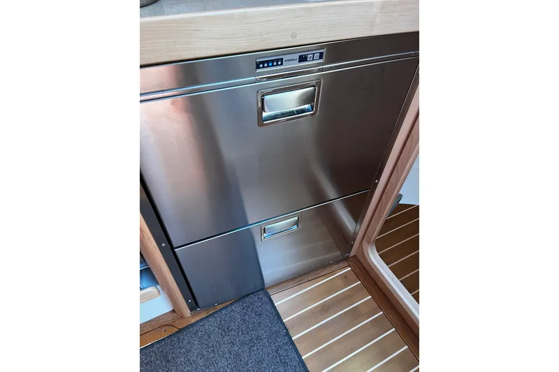 Slide: The Image of Stainless steel drawer in 2024 Tartan 395 yacht interior, featuring wooden flooring. - 16