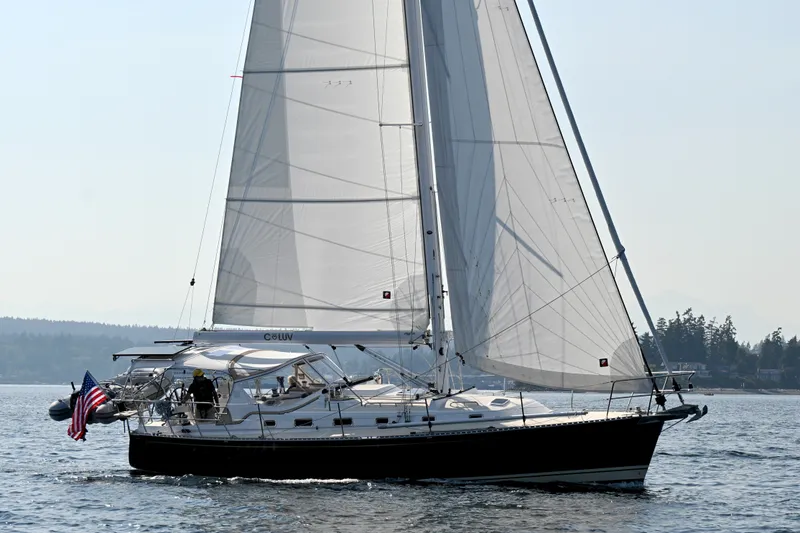 Slide: The Image of 2024 Tartan 395 sailboat cruising on calm waters with full sails. - 59