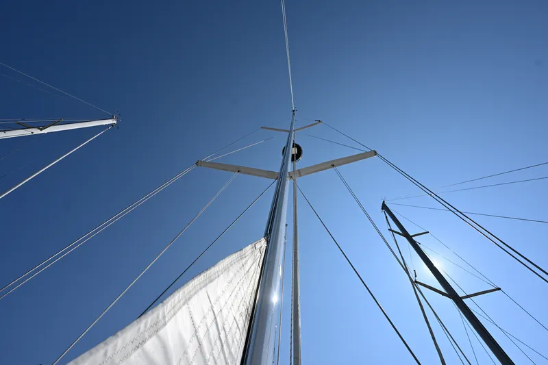 Slide: The Image of Looking up at the mast of a 2024 Tartan 395 sailboat against a clear blue sky. - 29