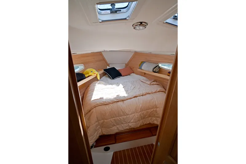 Slide: The Image of Cozy cabin interior of 2024 Tartan 395 yacht with skylight and bedding. - 5