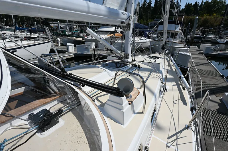 Slide: The Image of 2024 Tartan 395 sailboat docked at marina, showcasing sleek deck design and rigging. - 25