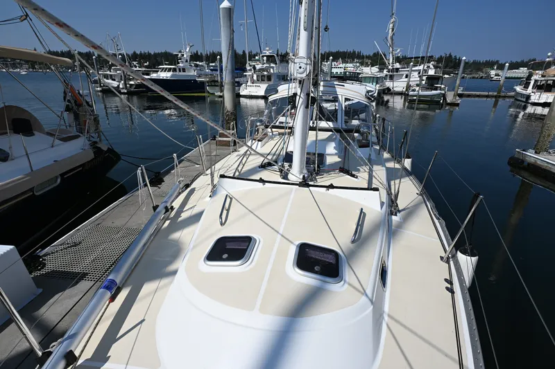 Slide: The Image of 2024 Tartan 395 sailboat docked at a marina, surrounded by other boats. - 33