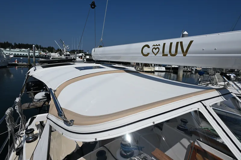 Slide: The Image of 2024 Tartan 395 sailboat docked at marina, featuring "C♥LUV" on the boom. - 37
