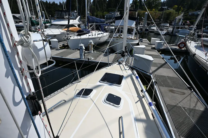 Slide: The Image of 2024 Tartan 395 sailboat docked at a marina with other boats. - 30