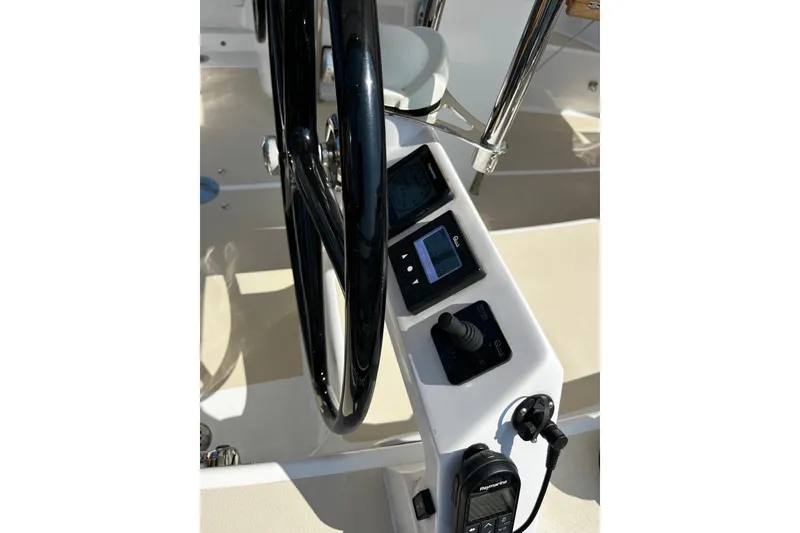 Slide: The Image of Steering wheel and control panel of 2024 Tartan 395 yacht, featuring navigation instruments. - 48