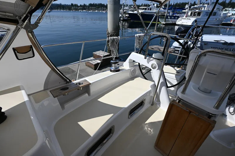 Slide: The Image of 2024 Tartan 395 yacht cockpit with steering wheel, docked at marina. - 45