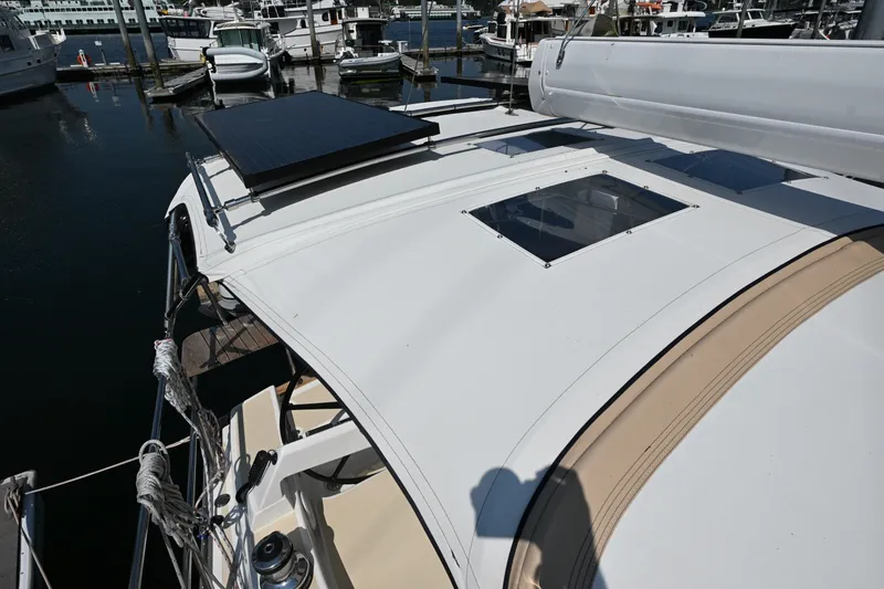 Slide: The Image of 2024 Tartan 395 yacht with solar panel and skylight, docked at marina. - 38