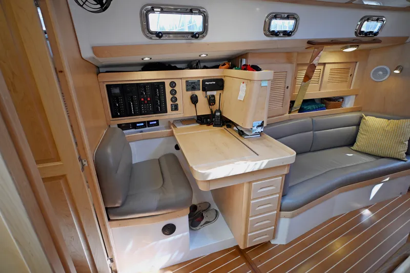 Slide: The Image of 2024 Tartan 395 yacht interior with navigation station and seating area. - 7