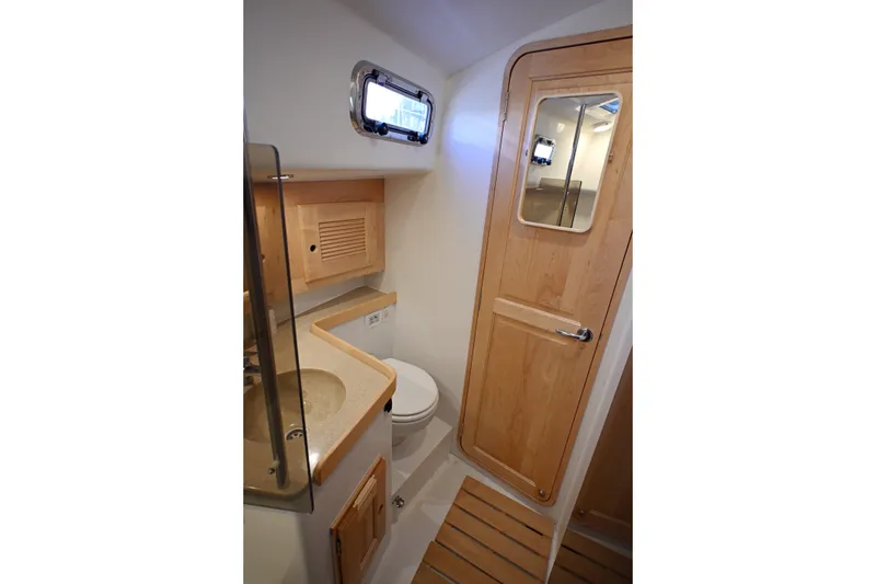 Slide: The Image of 2024 Tartan 395 yacht bathroom with wooden cabinetry and modern fixtures. - 13