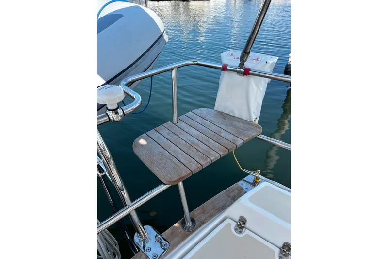 Slide: The Image of Teak swim platform on 2024 Tartan 395 sailboat, docked by calm water. - 51