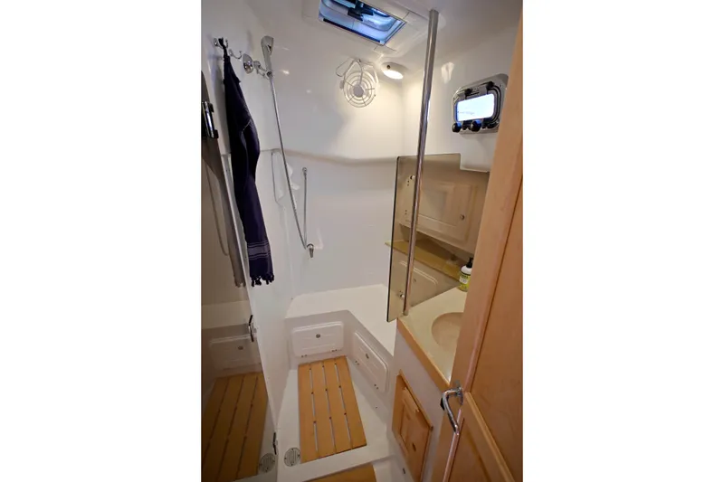Slide: The Image of Compact bathroom interior of 2024 Tartan 395 yacht, featuring modern fixtures and wooden accents. - 12
