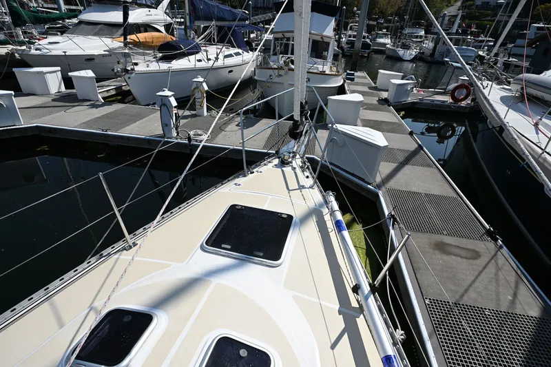 Slide: The Image of 2024 Tartan 395 sailboat docked at a marina, showcasing its sleek deck design. - 31