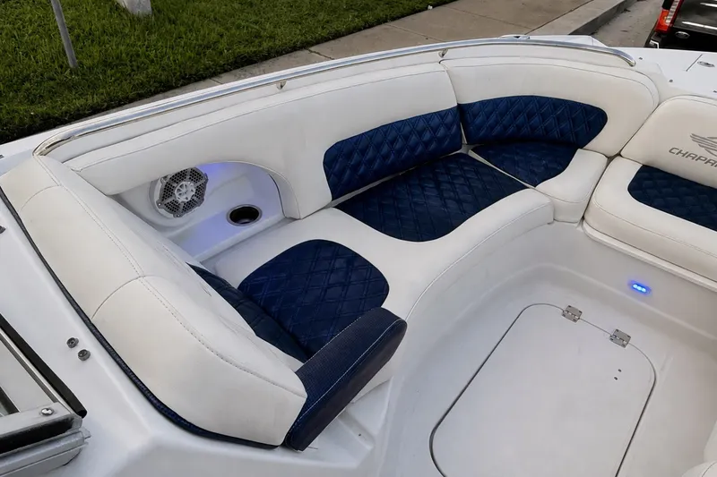 Slide: The Image of Luxurious seating on 2013 Chaparral 287 SSX boat with blue and white upholstery. - 24