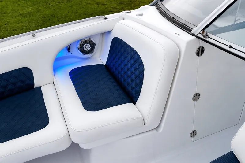 Slide: The Image of 2013 Chaparral 287 SSX boat interior with blue and white seating, speaker, and ambient lighting. - 27