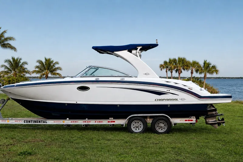 The Image of 2013 Chaparral 287 SSX boat on trailer by lake, palm trees in background. - 0