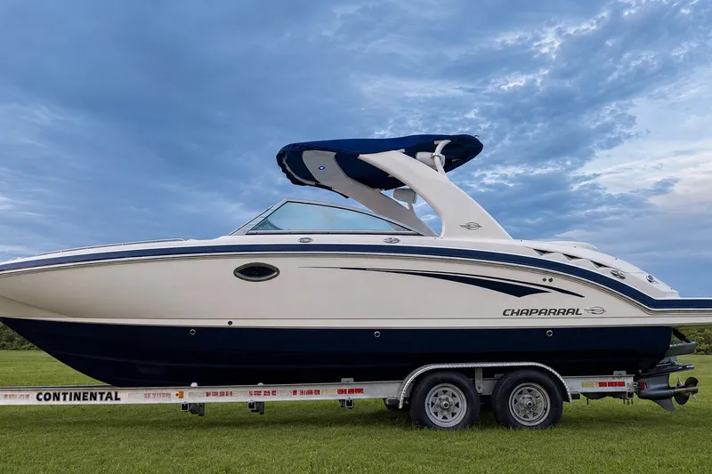 Slide: The Image of 2013 Chaparral 287 SSX boat on trailer against a cloudy sky backdrop. - 3