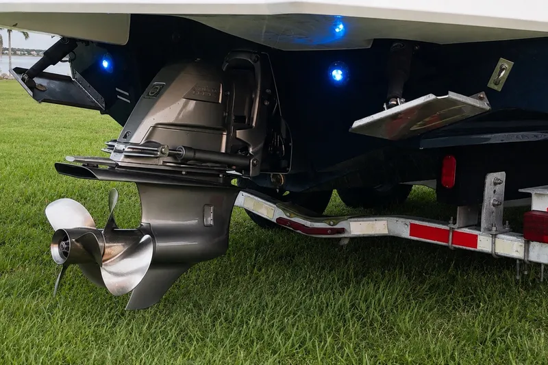Slide: The Image of 2013 Chaparral 287 SSX boat stern with propeller and trailer on grass. - 15