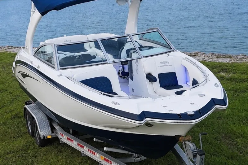 Slide: The Image of 2013 Chaparral 287 SSX boat on trailer by a lake. - 6