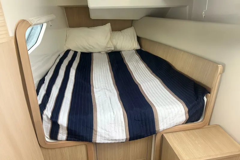 Slide: The Image of Cozy cabin interior of 2023 Aquila 36 Sport with striped bedding. - 22