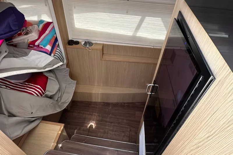 Slide: The Image of Interior of 2023 Aquila 36 Sport, featuring cozy bedding and modern wooden finishes. - 25
