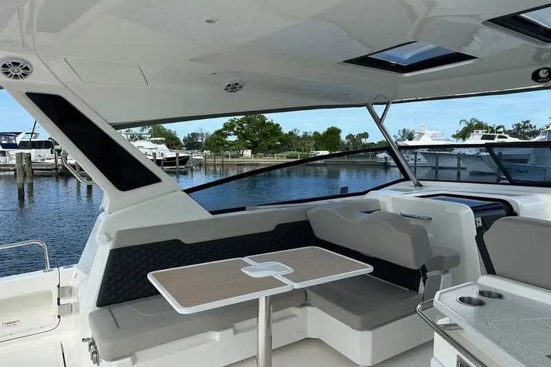 Slide: The Image of Interior view of 2023 Aquila 36 Sport yacht with seating and table by the water. - 15