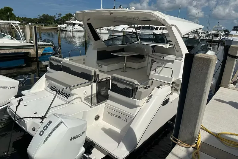 Slide: The Image of 2023 Aquila 36 Sport boat docked, featuring spacious seating and twin Mercury engines. - 21