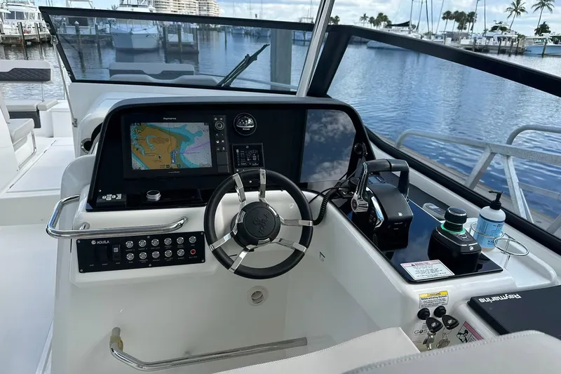 Slide: The Image of Helm of 2023 Aquila 36 Sport boat with navigation system and controls. - 12