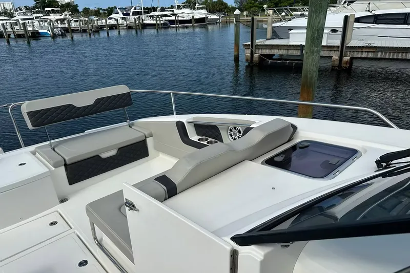 Slide: The Image of 2023 Aquila 36 Sport boat interior with seating, docked at marina. - 7
