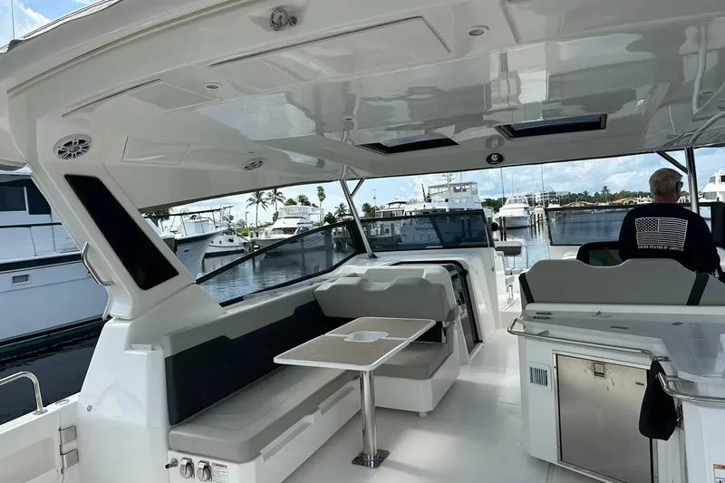 Slide: The Image of 2023 Aquila 36 Sport yacht interior with seating and table, docked at marina. - 16