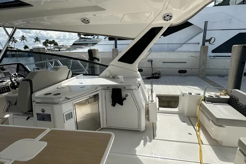 Slide: The Image of 2023 Aquila 36 Sport yacht interior with helm, seating, and dock view. - 18