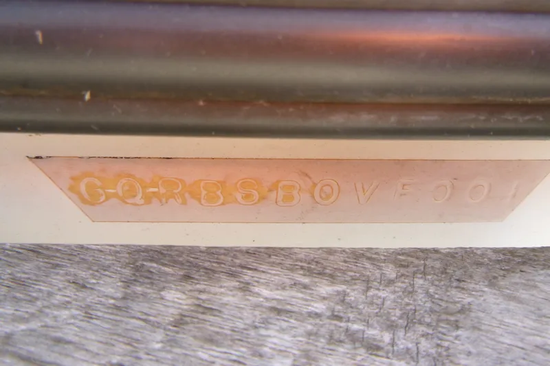 Slide: The Image of Close-up of a metal plate with embossed characters on an Infinity ZX-1, 2001 model. - 14
