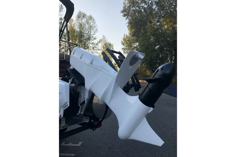 Slide: The Image of 2023 Bennington 22 LSB boat motor, sleek design, outdoors with trees in background. - 7