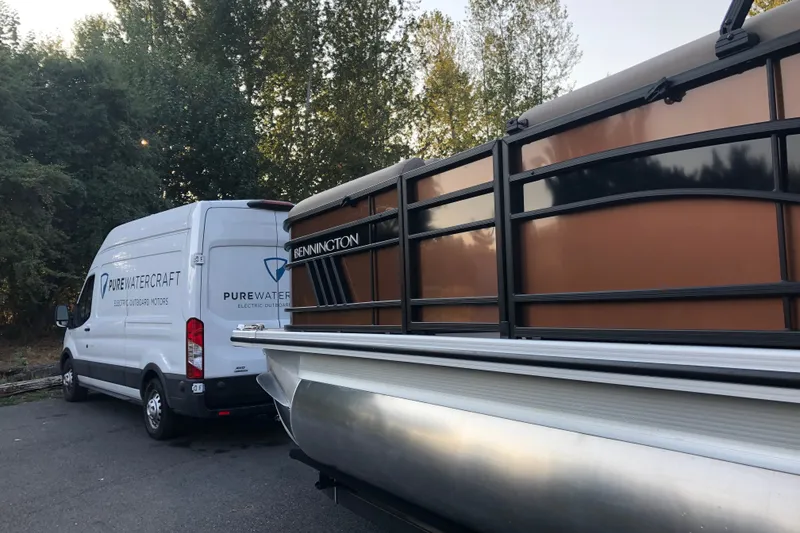 Slide: The Image of 2023 Bennington 22 LSB pontoon boat beside Pure Watercraft van. - 5