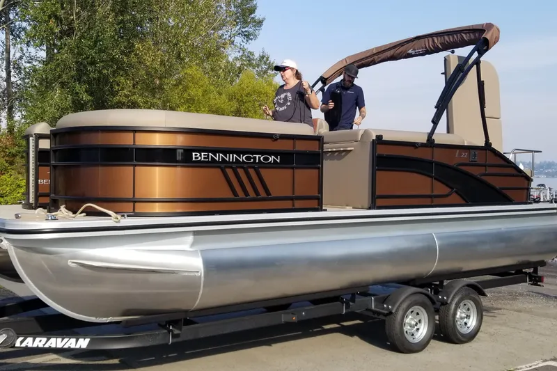 Slide: The Image of 2023 Bennington 22 LSB pontoon boat on trailer, featuring sleek design and modern amenities. - 2
