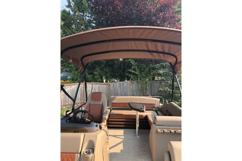 Slide: The Image of 2023 Bennington 22 LSB pontoon boat interior with canopy and seating. - 16
