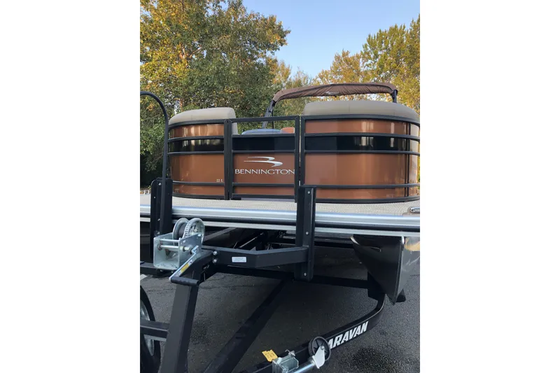 Slide: The Image of 2023 Bennington 22 LSB pontoon boat on trailer, featuring sleek design and brown exterior. - 9