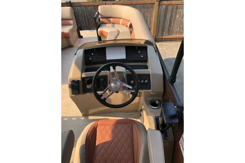 Slide: The Image of 2023 Bennington 22 LSB boat interior with steering wheel and seating. - 14