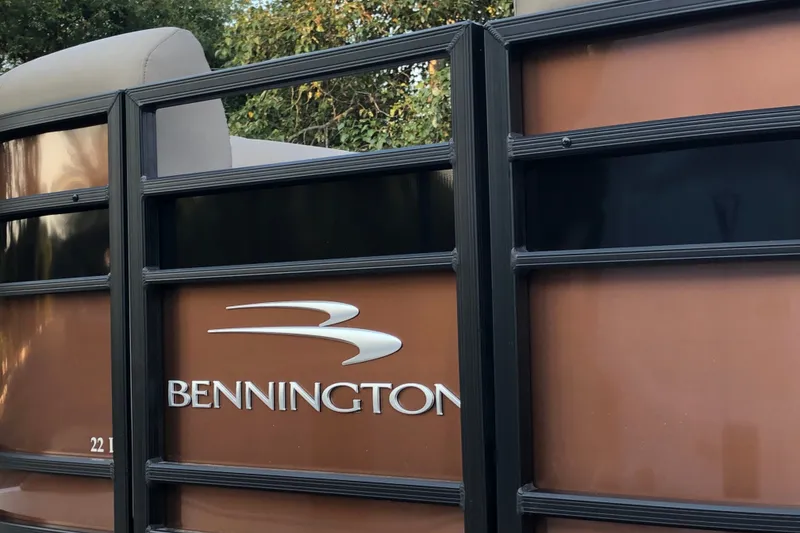 Slide: The Image of 2023 Bennington 22 LSB pontoon boat with sleek design and logo. - 10