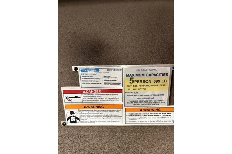 Slide: The Image of Safety and capacity warning labels for Xpress X18DB boat, 2027 model. - 16
