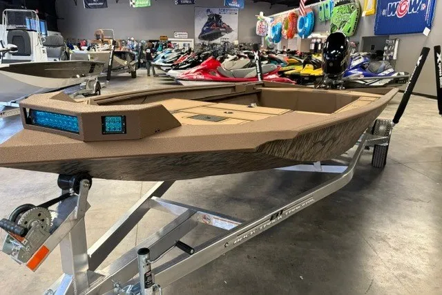 The Image of 2027 Xpress X18DB boat on trailer in showroom with various watercraft. - 1