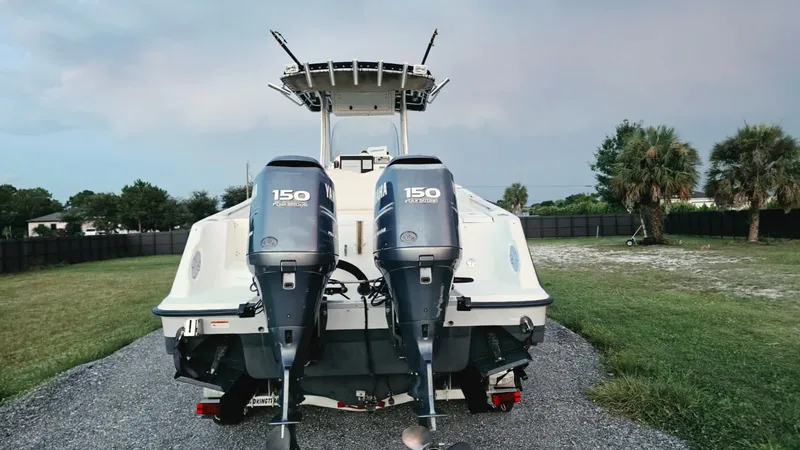 Slide: The Image of A 2006 Hydra-Sports 2500 CC with twin outboard engines, on a trailer in a grassy area. - 3