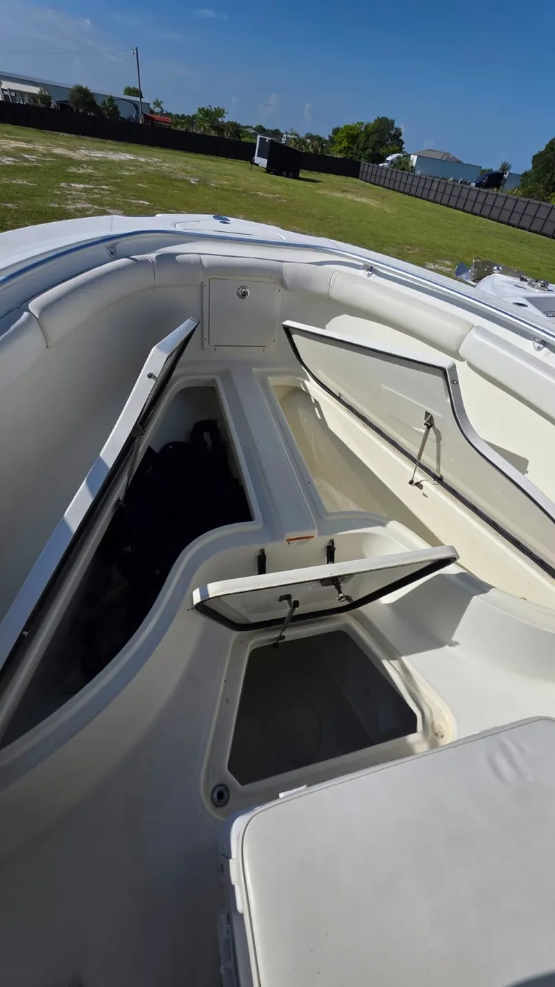 Slide: The Image of The image shows the open deck of a 2006 Hydra-Sports 2500 CC boat with storage compartments. - 9