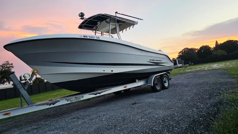 Slide: The Image of A 2006 Hydra-Sports 2500 CC on a trailer, parked against a colorful sunset backdrop. - 2